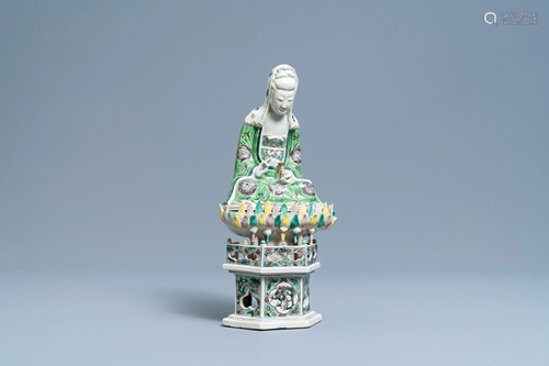 A Chinese verte biscuit group of Guanyin on a lotus