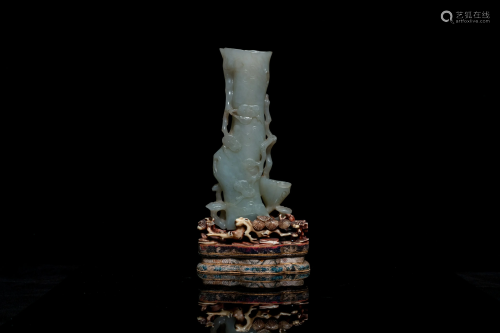 A Chinese jade vase on reticulated stand, Qing