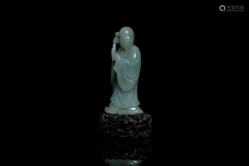 A Chinese carved celadon jade 'immortal' figure on