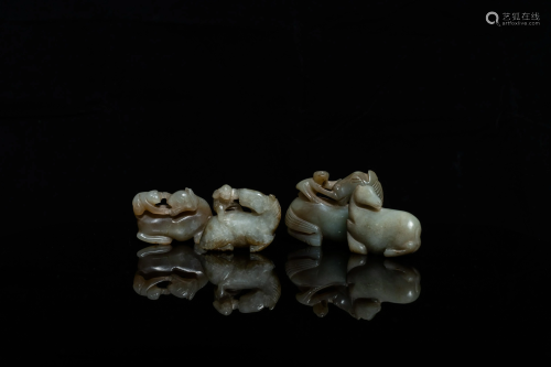Four Chinese celadon and russet jade carvings with