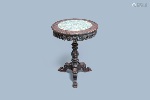 A Chinese carved wooden table with a large Canton