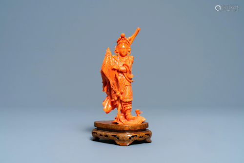 A Chinese carved red coral figure of a warrior holding
