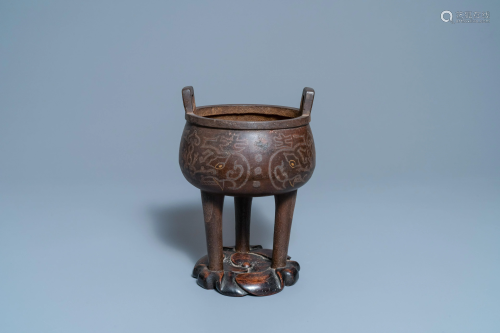 A Chinese inlaid bronze tripod censer on wooden stand,