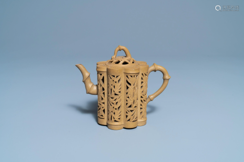 A Chinese reticulated Yixing stoneware teapot and