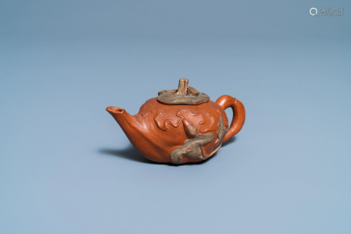 A Chinese relief-decorated Yixing stoneware teapot and