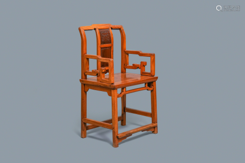 A Chinese wooden chair with inserted carved panels,