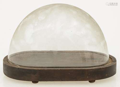 A low glass oval bell jar with wooden base, 19th century.