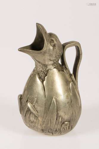 A small pewter jug in the shape of a hatching egg in tall grass, France, 1st half 20th century.