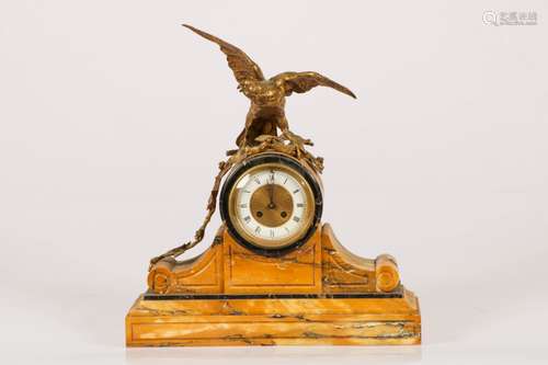 A marble chimney pendulum with bronze sculpture of an eagle resting on a vine-branch..