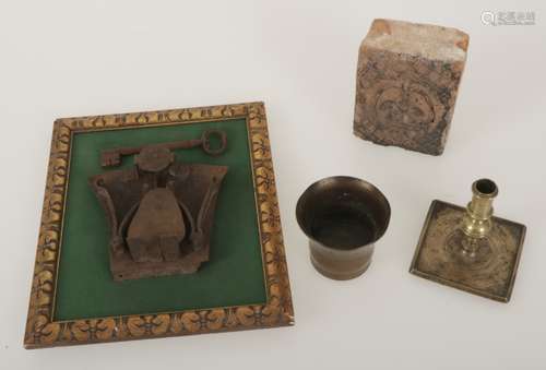 A lot with various items, amongst which a 'haardsteen', candle holder and lock.