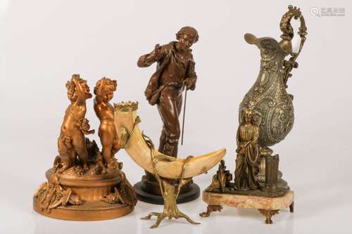 A lot with consisting of a Zamac sculpture of a walking man, a dito of two putti, one bronze, a pitc