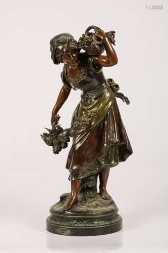 A bronze sculpture of a young girl with fruitbasket, France, late 19th century.