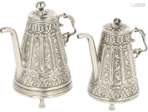 Miniature silver jugs.