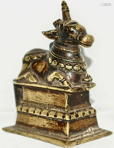 A brass sitting Nandi ( Cow ) with Jewellery