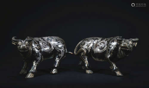 A pair of bronze cattle ware with silver