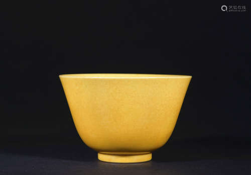 A yellow glazed cup