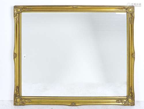 A REPRODUCTION GILT FRAMED BEVELLED MIRROR, FOLIATE CLASPED TO THE CORNERS WITHIN A BEADED SLIP,
