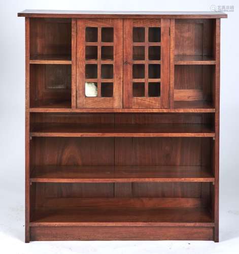 AN ARTS AND CRAFTS WALNUT BOOKCASE, C1900, THE OVERSAILING RECTANGULAR TOP ABOVE A PAIR OF GLAZED