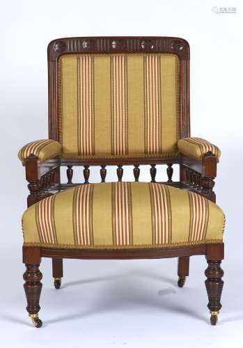 A LATE VICTORIAN MAHOGANY ARMCHAIR, THE TOP RAIL FLUTED AND CARVED FIVE ROSETTES, UPHOLSTERED