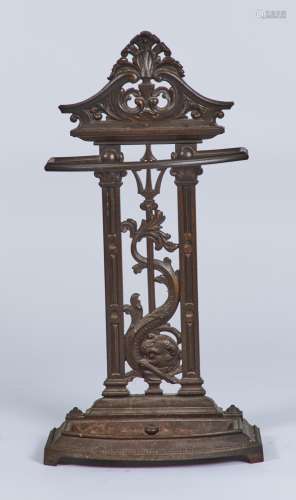 A VICTORIAN CAST IRON UMBRELLA STAND, C1870, THE UPRIGHT BACK WITH SWAN NECK TOP, VERTICAL DOLPHIN
