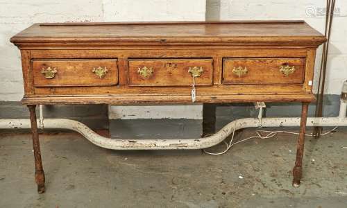 A GEORGE III PINE DRESSER BASE, C1780, THE TOP WITH PLANTED MOULDING TO THE LIP ABOVE THREE SHORT