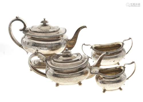 A GEORGE IV GADROONED SILVER TEA AND COFFEE SERVICE, ENGRAVED WITH BANDS OF FOLIAGE AND INITIALLED