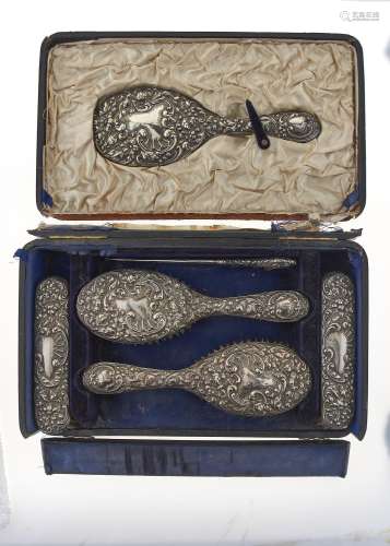 AN EDWARDIAN FIVE PIECE SILVER BRUSH SET BY W G KEIGHT & CO, BIRMINGHAM 1903 AND A SILVER HANDLED