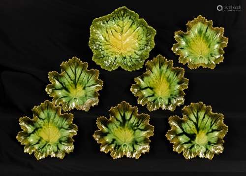 A BRETBY LEAF SHAPED MAJOLICA DESSERT SERVICE, C1900, COMPRISING SIX PLATES AND A STAND ON RED