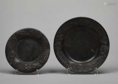 TWO GRADUATED MATT BLACK PAINTED TERRACOTTA DISHES, C1870, SPRIGGED WITH FLOWERS AND FERNS, 18.5 AND