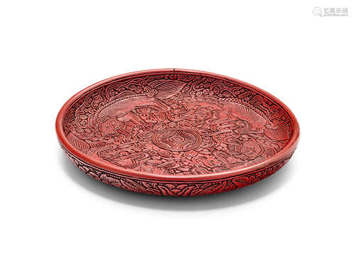 A carved cinnabar lacquer 'four Buddhist lions' circular dish 16th/17th Century