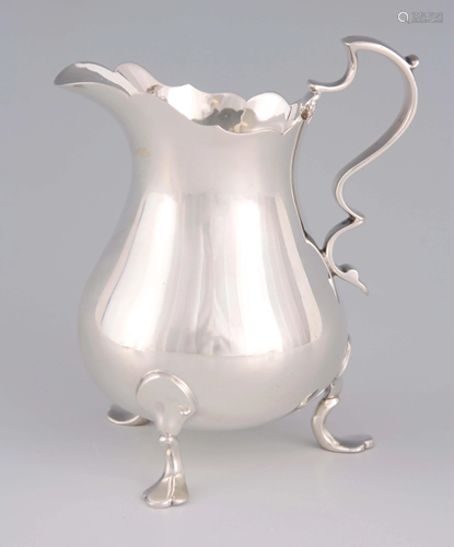 AN ELIZABETH II SILVER CREAM JUG with shaped handle,