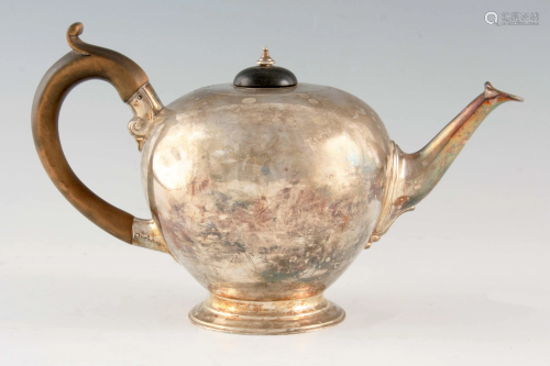 A VICTORIAN SILVER TEAPOT of bulbous form with hardwood