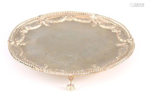 A GEORGE III SILVER SALVER with reed-edged border and