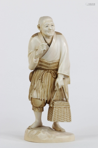 Japan okimono carved with a character in a basket