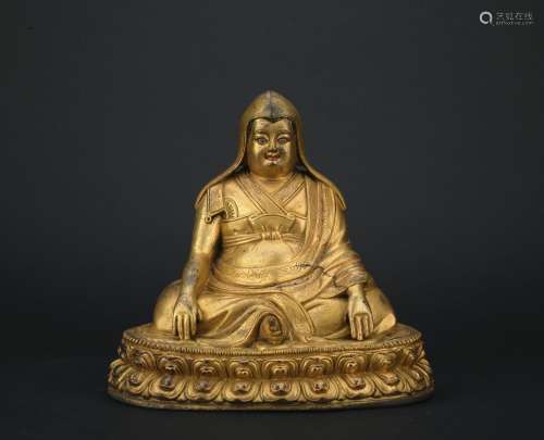 A gilt-bronze figure of Guru
