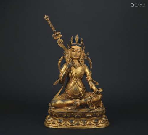 A gilt-bronze figure of Dharmapalas