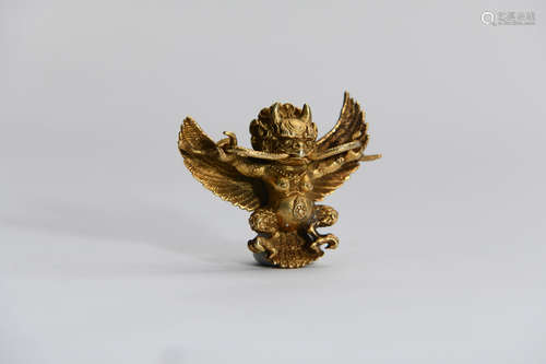 A GILDING COPPER BIRD