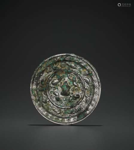 A RARE SILVERED BRONZE ‘LIONS AND GRAPEVINES’ MIRROR, TANG