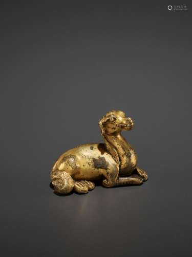 A RARE GILT BRONZE ‘RECUMBENT HOUND’ WEIGHT, MING OR EARLY QING