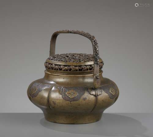 A ‘HUNDRED HORSES’ BRONZE HANDWARMER WITH RETICULATED COVER, LATE MING TO EARLY QING