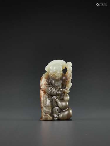 A PALE CELADON, GRAY AND RUSSET JADE FIGURE OF DONGFANG SHUO, QING DYNASTY