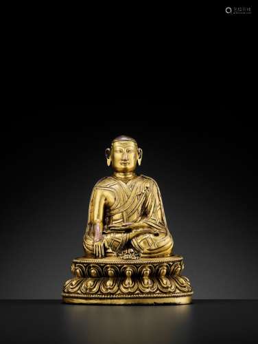 A TIBETAN GILT-BRONZE FIGURE OF A LAMA, 13TH-14TH CENTURY