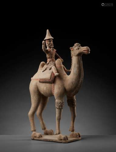 A LARGE PAINTED POTTERY BACTRIAN CAMEL WITH RIDER, TANG DYNASTY