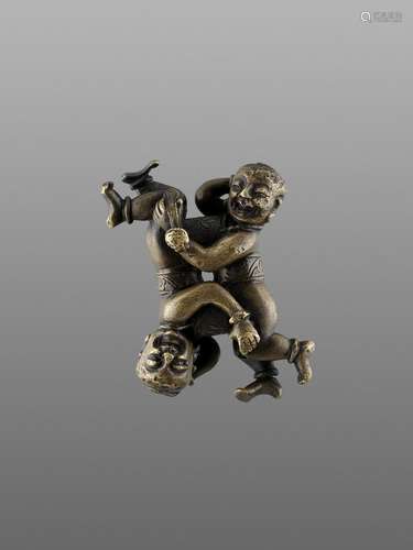 A 'TWIN BOYS' BRONZE SCROLL WEIGHT, MING DYNASTY