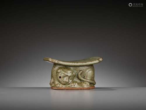 A YAOZHOU CELADON ‘TIGER’ PILLOW OR WRIST REST WITH OFFICIAL MARK, LATE TANG TO EARLY SONG