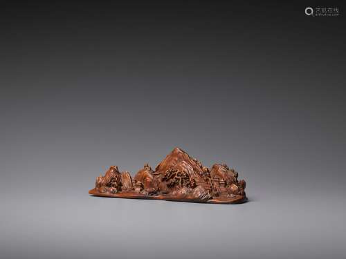 A CARVED BOXWOOD ‘MOUNTAIN LANDSCAPE’ BRUSH REST, LATE QING TO REPUBLIC