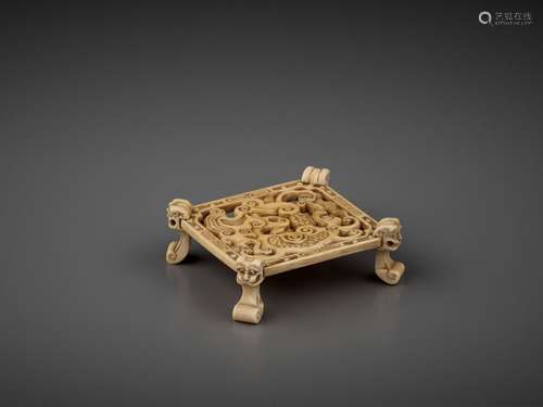 A CARVED OPENWORK IVORY ‘MYTHICAL BEAST’ STAND, QING DYNASTY