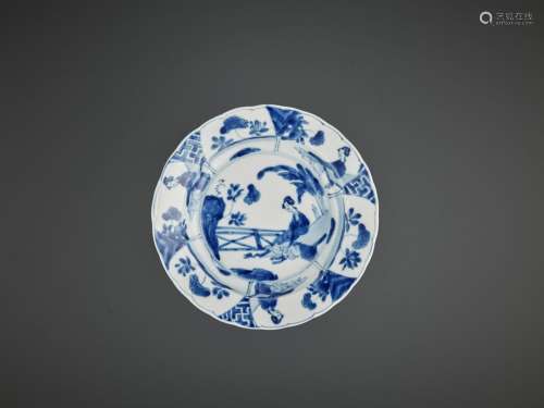 A BLUE AND WHITE ‘LADY IN A GARDEN’ LOBED DISH, KANGXI MARK AND PERIOD