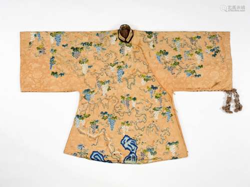 AN APRICOT-GROUND EMBROIDERED SILK ‘SQUIRRELS AND GRAPES’ ROBE, QING DYNASTY