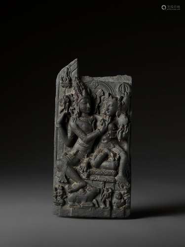 AN INDIAN BLACK STONE STELE DEPICTING UMA-MAHESHVARA, PALA PERIOD